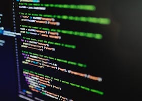 High-resolution image of colorful programming code highlighted on a computer screen.