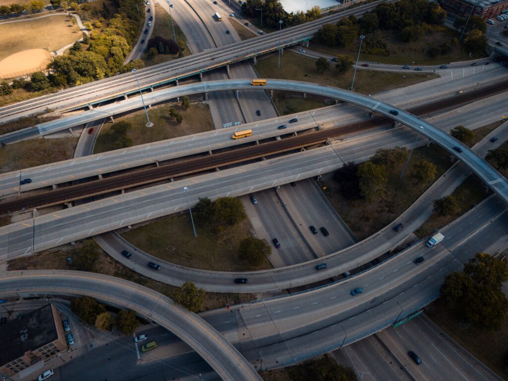 Intricate aerial view of a busy multi-level highway interchange in an urban area.