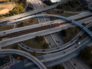 Intricate aerial view of a busy multi-level highway interchange in an urban area.